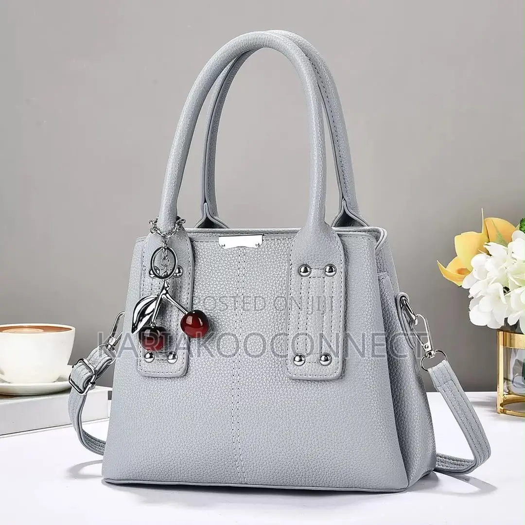 Elegant Handbag With Cherry Charm and Shoulder Strap