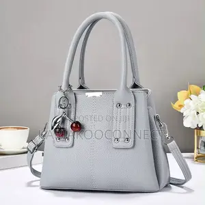 Elegant Handbag With Cherry Charm and Shoulder Strap
