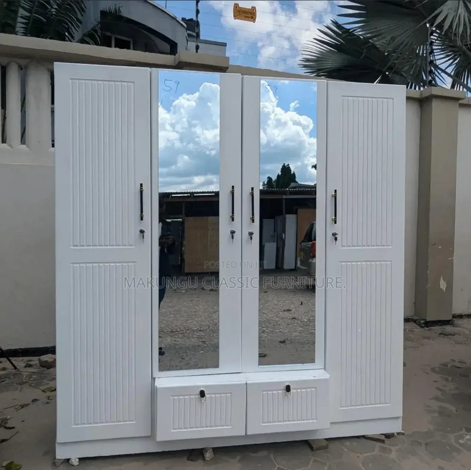 Four Doors Wardrobe With Mirrored Feature.