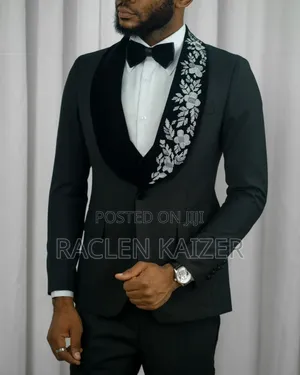 A Black Jacket Suits With Velvet Lapels Adorned With White Embroidery