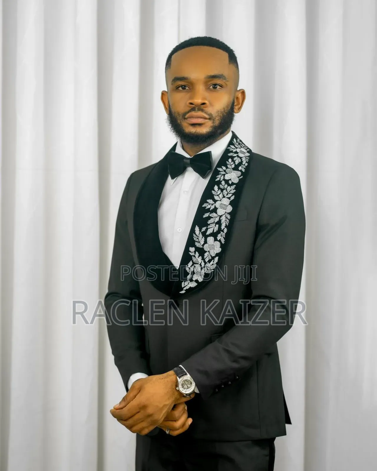 A Black Jacket Suits With Velvet Lapels Adorned With White Embroidery