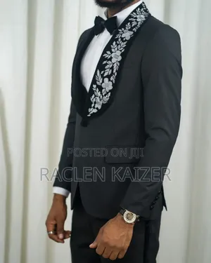 A Black Jacket Suits With Velvet Lapels Adorned With White Embroidery