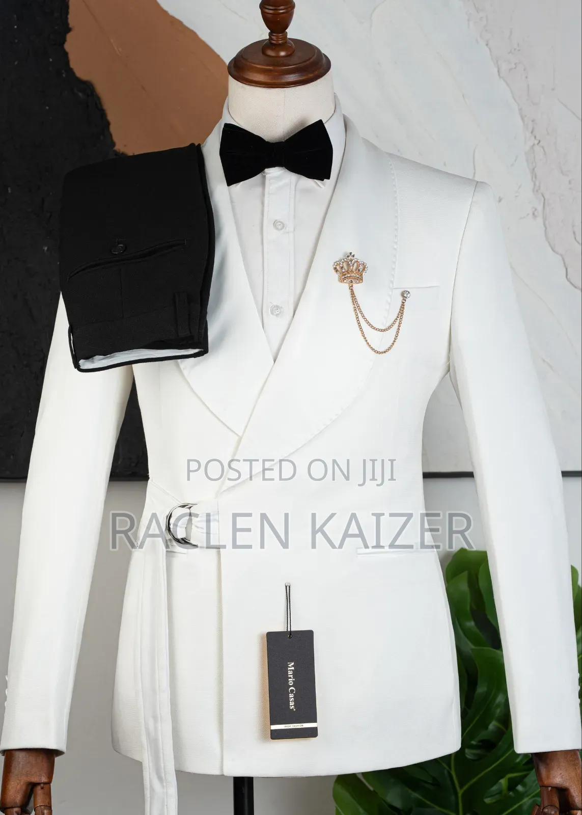 A White Suits Features a Distinctive Belt Detail at the Waist
