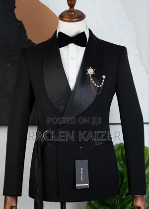 A Black Suits Features a Distinctive Belt Detail at the Waist