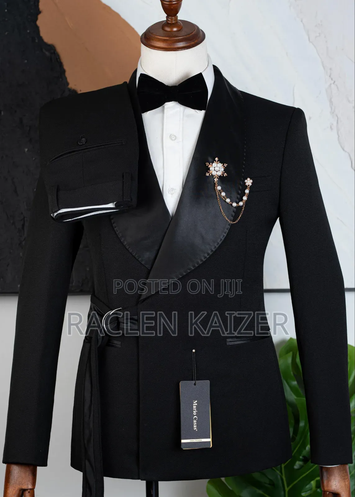 A Black Suits Features a Distinctive Belt Detail at the Waist