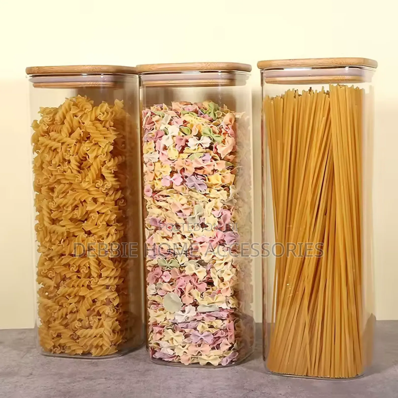 Three Glass Storage Jars With Bamboo Lids.