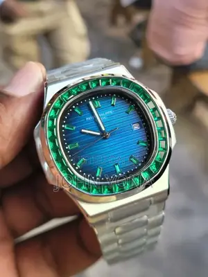 Patek Philippe Nautilus Watch With a Custom Bezel Set Green Emeralds