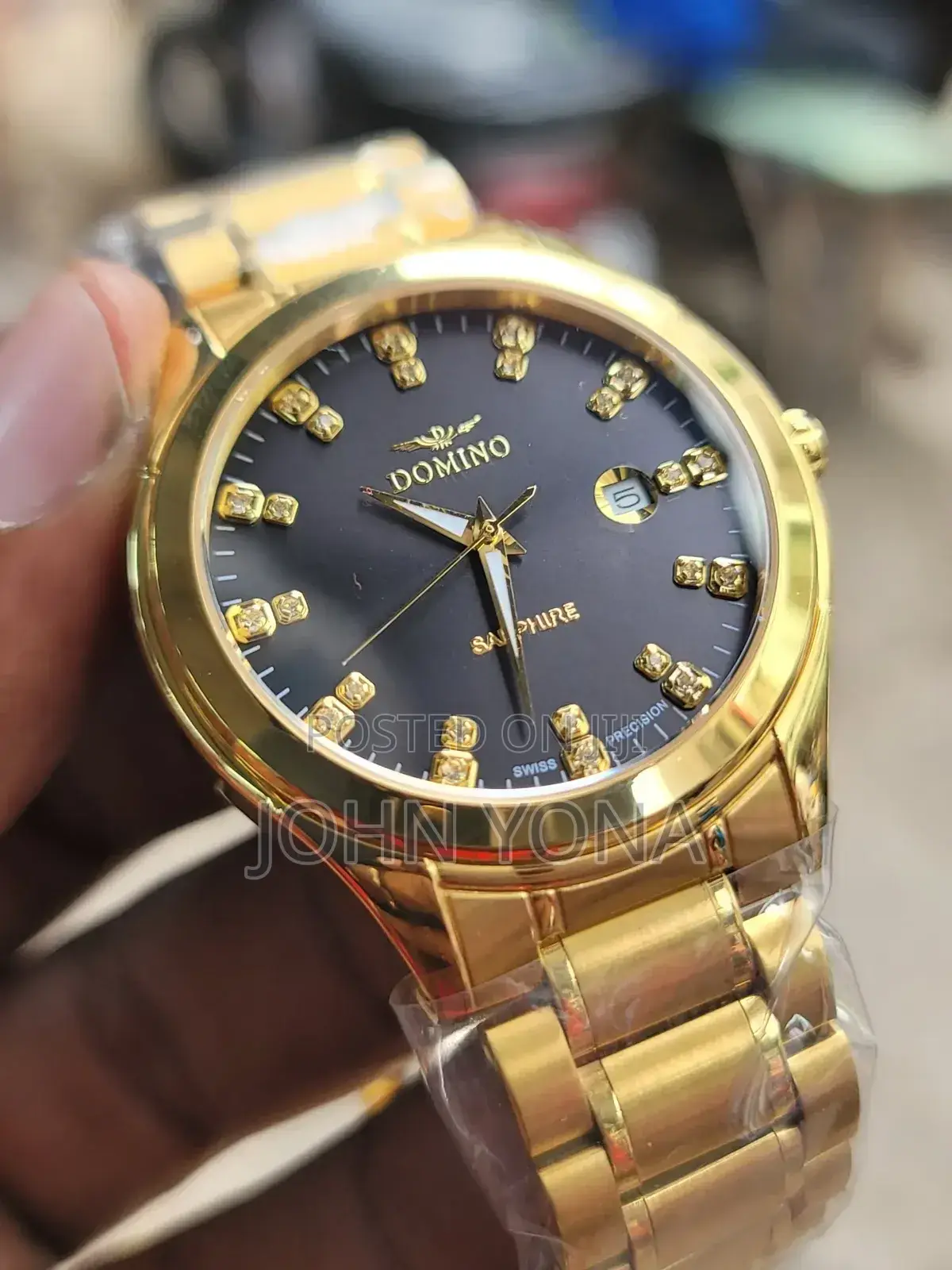 Domino Stainless Steel Watch With a Gold-Colored Band and a Black Dial