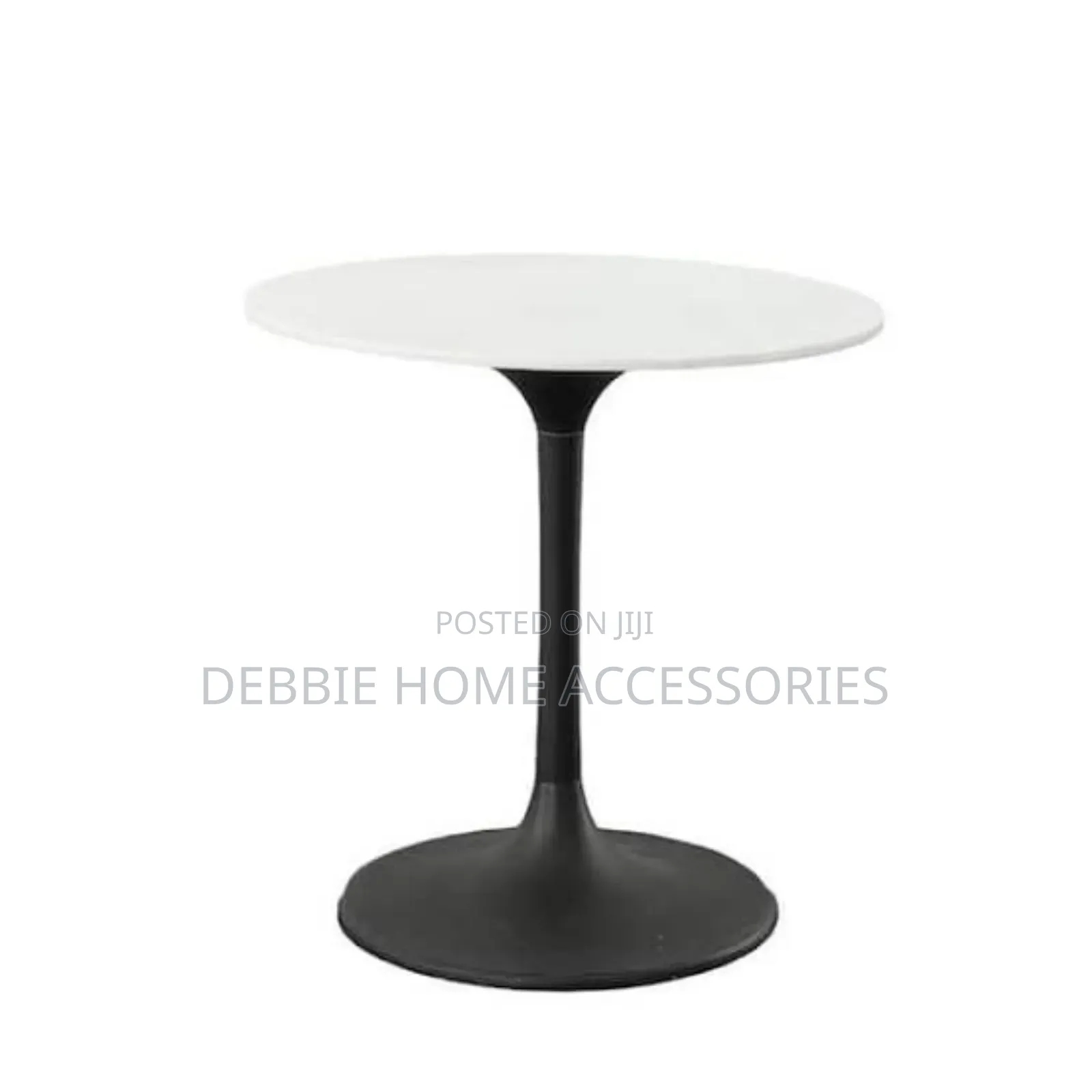 Round Dining Table With a White Marble Top and a Black Base.