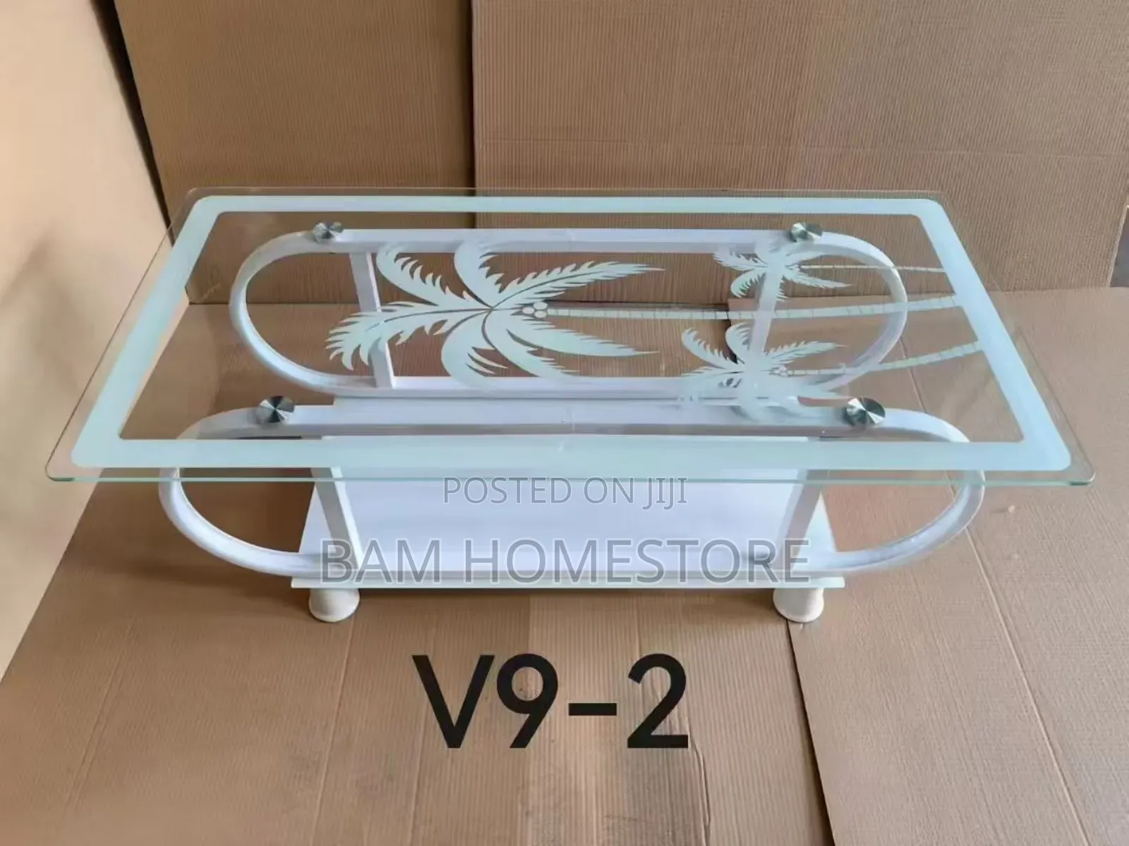 Elegant Glass Coffee Table Withpalm Tree Design and Curved Metal Frame