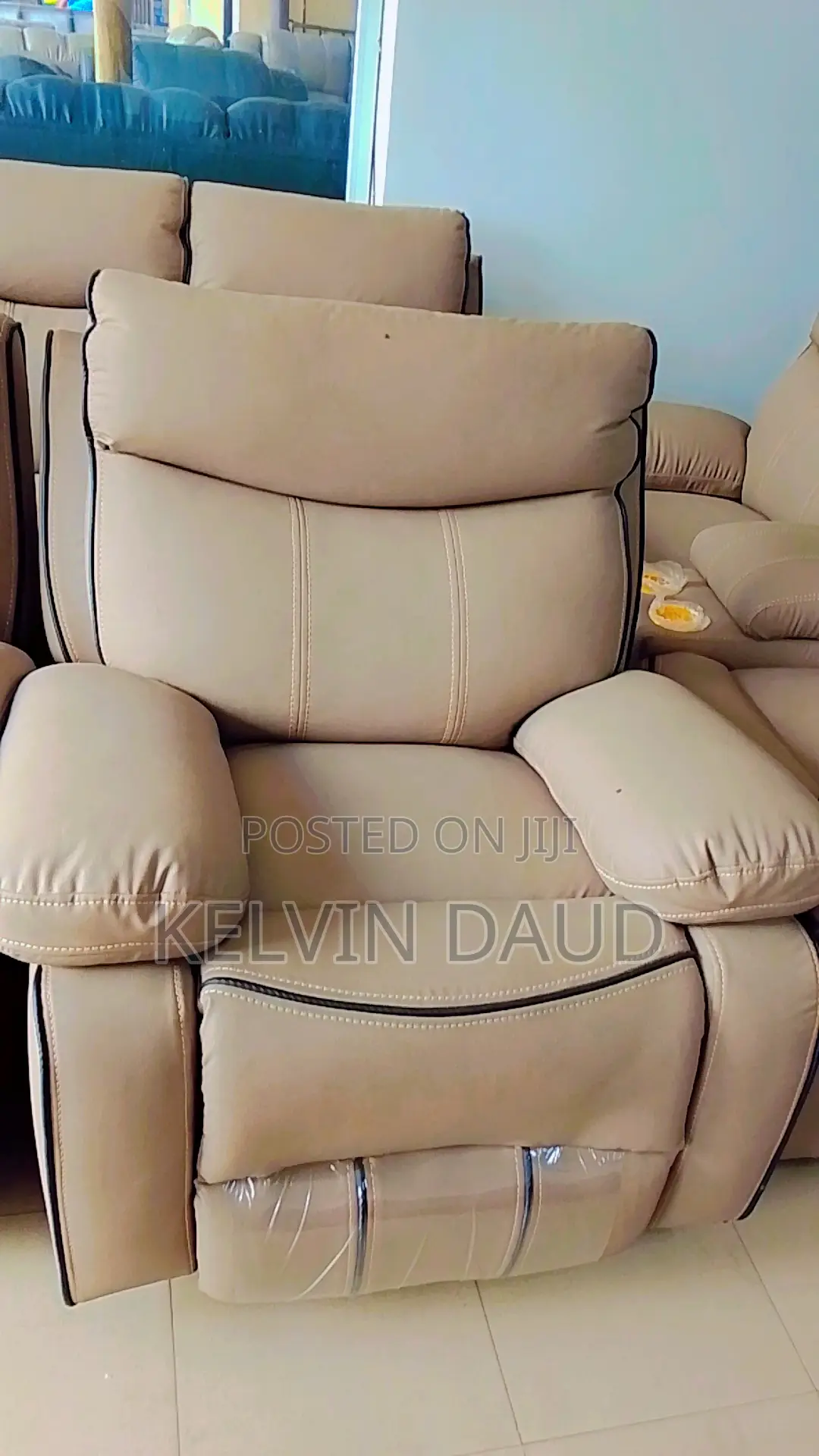 A Beige Leather Sofa With a Black Piping.