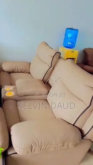 A Beige Leather Sofa With a Black Piping.