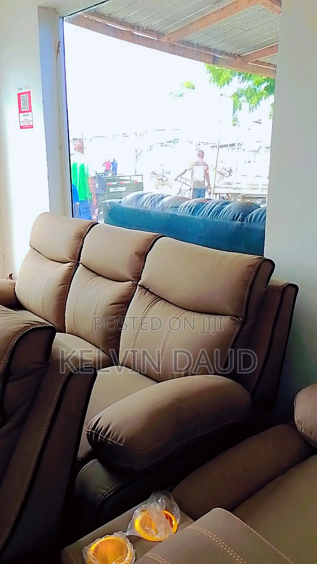 A Beige Leather Sofa With a Black Piping.