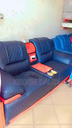 A Set With Dark Blue Leather Sofa With Red Accents