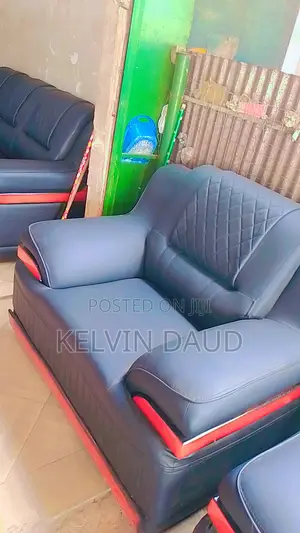 A Set With Dark Blue Leather Sofa With Red Accents