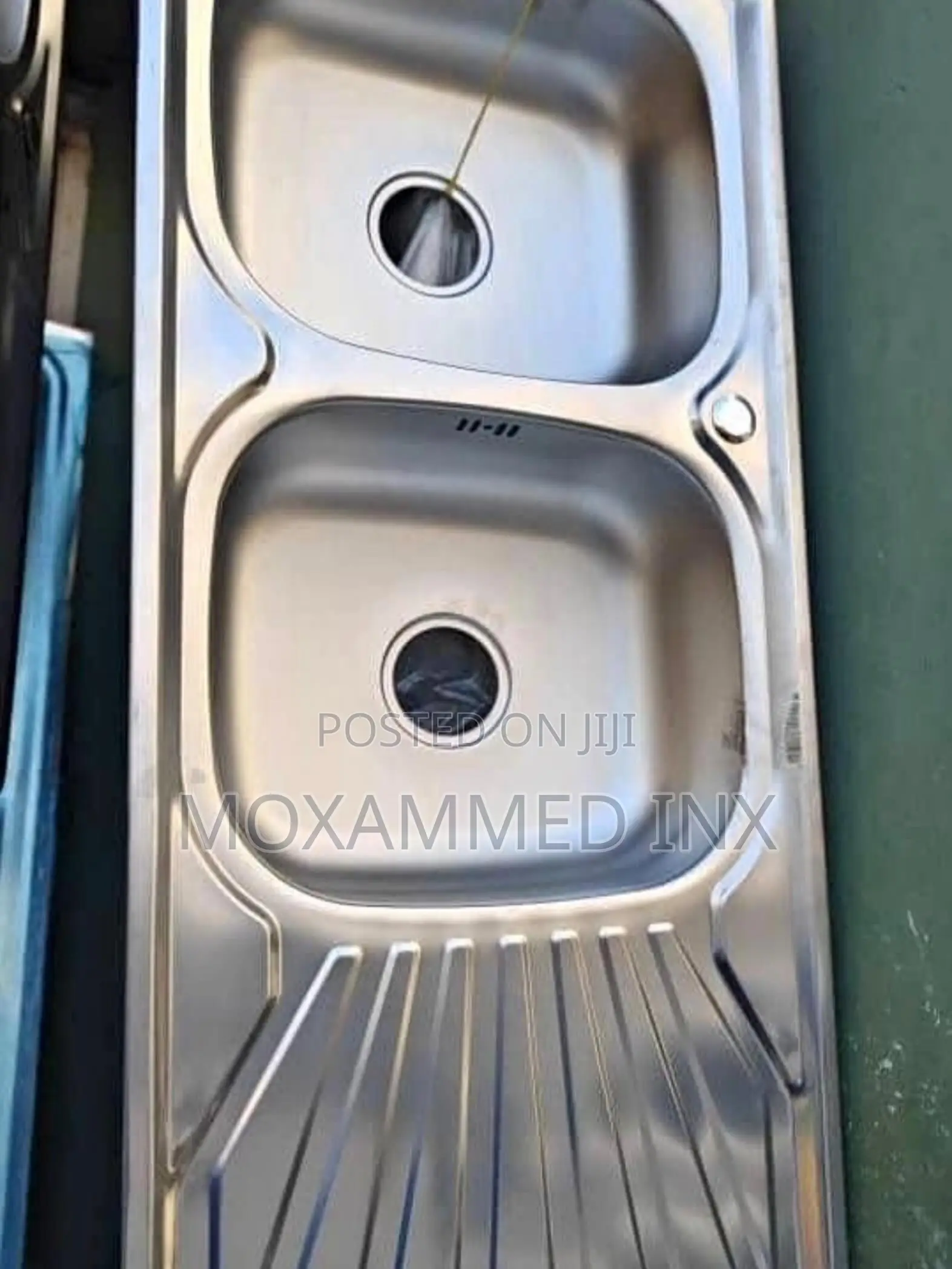 Stainless Steel Kitchen Sink That Features Double Bowls and a Single