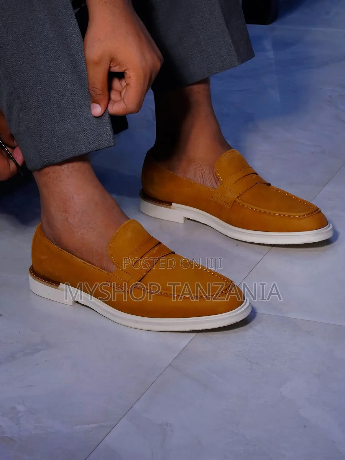 Tan Suede Loafers Feature a Prominent White Rubber Sole