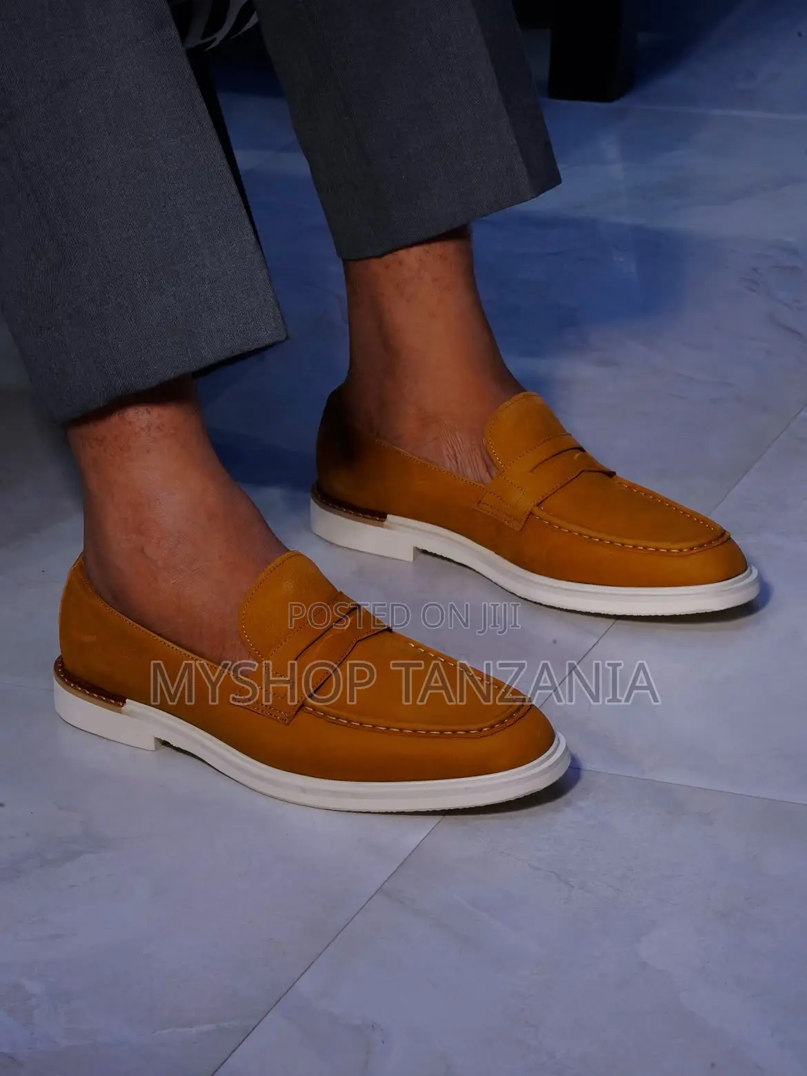 Tan Suede Loafers Feature a Prominent White Rubber Sole