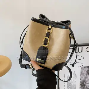 Neutral Bucket Handbag Features Dark Brown Leather Trim