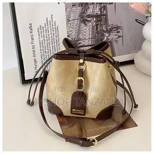 Neutral Bucket Handbag Features Dark Brown Leather Trim