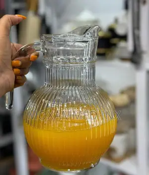 Ribbed Glass Juice and Water Pitcherfeatures a Rounded, Bulbous Base,
