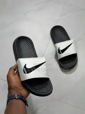 NIKE BENASSI SLIDES Feature a Textured Footbed
